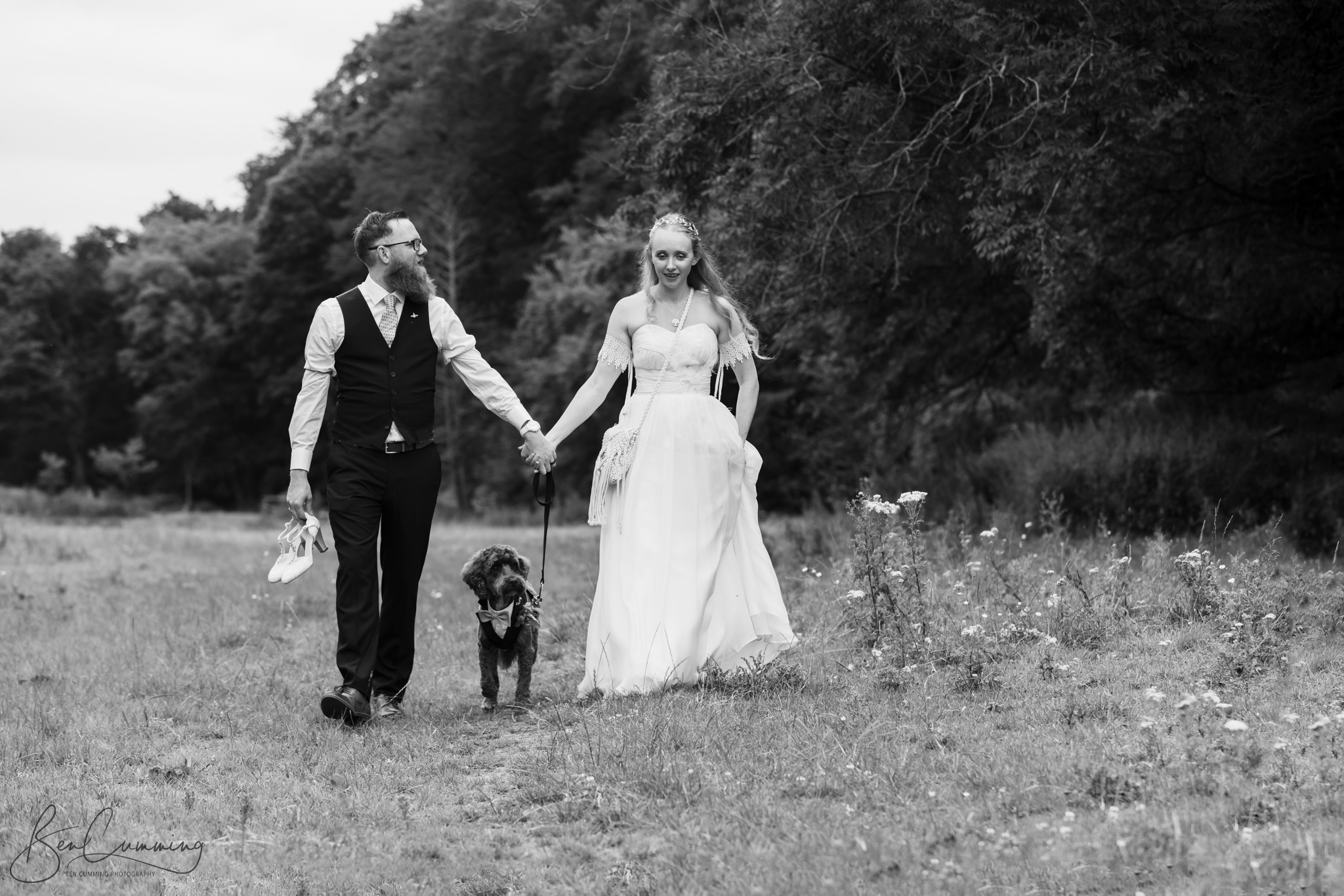 Bride and Groom walking the dog on their wedding day at the Venue Bowers Mill